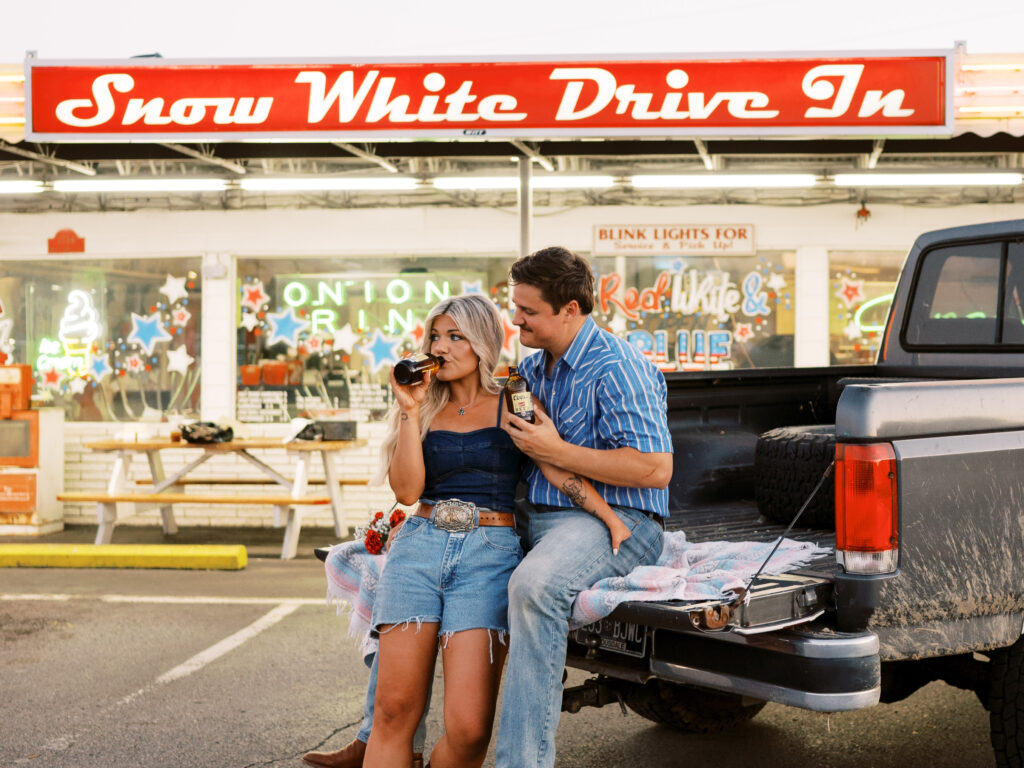 Engaged couple in front of drive in diner
