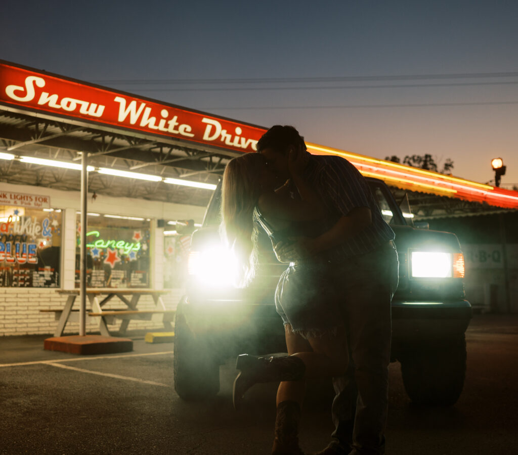 Engaged couple in front of drive in diner