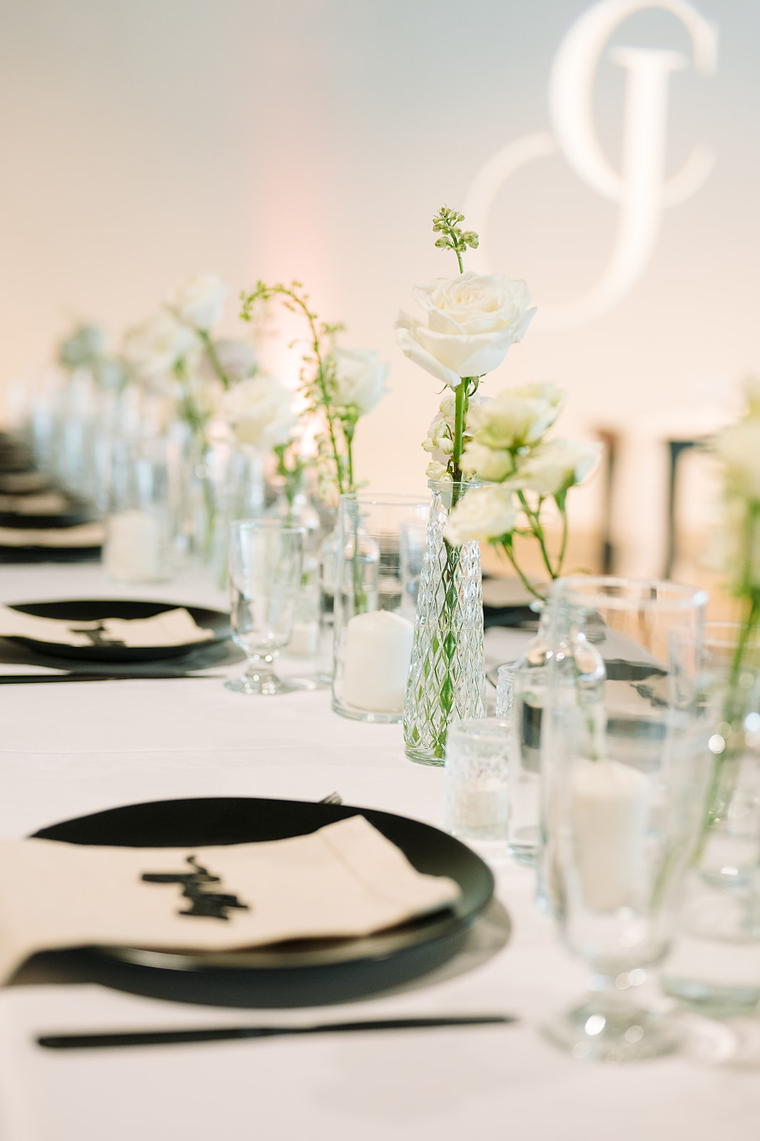 Details of a wedding reception table setup with white roses