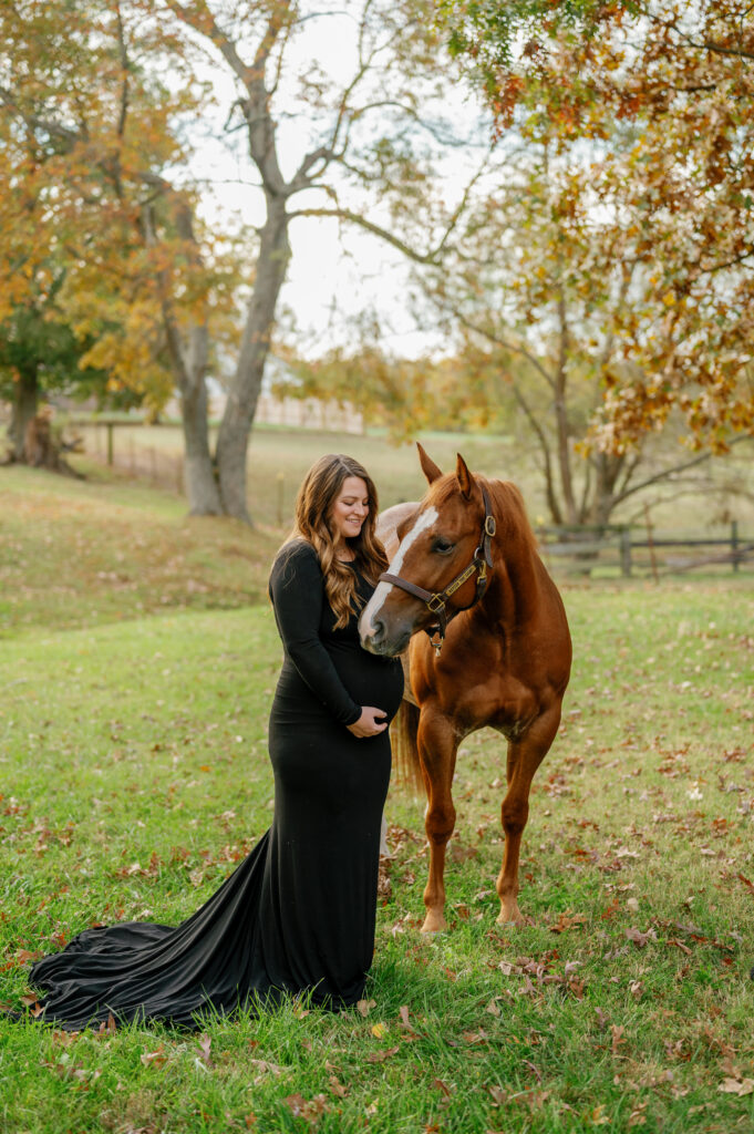 Expectant mother poses for Western maternity pictures with her horse near Nashville, Tennessee. 