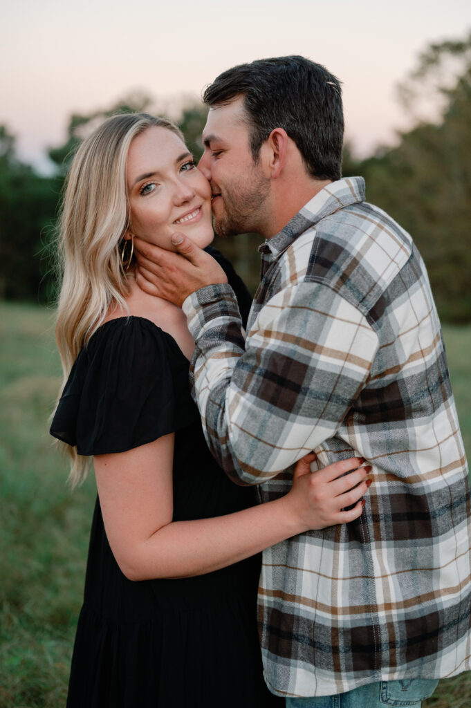Couple posing in field for their Nashville Engagement pictures. 