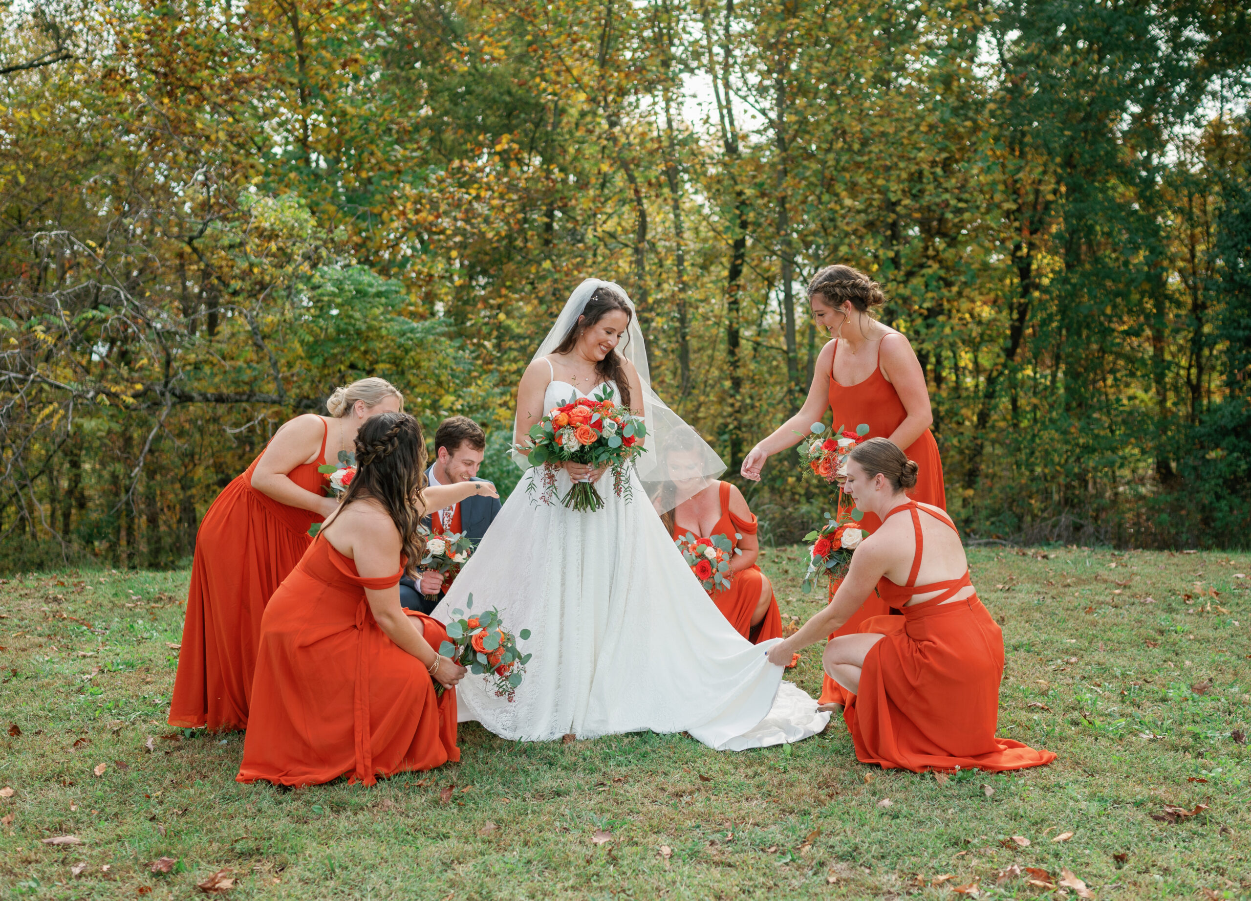Bridesmaids fluffing Nashville bride's dress