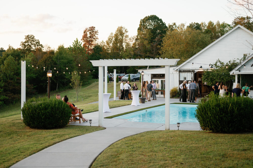 Cocktail hour by the pool at Front Porch Farms wedding venue. 