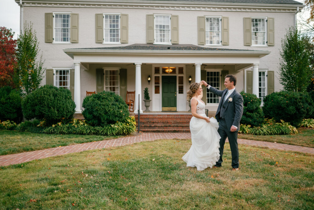 Newly wed couple posing in front of Maple Grove Estate wedding venue. 