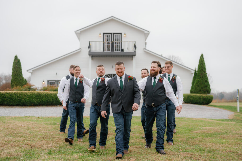 Groomsmen and groom walking in front of Kentucky wedding venue.