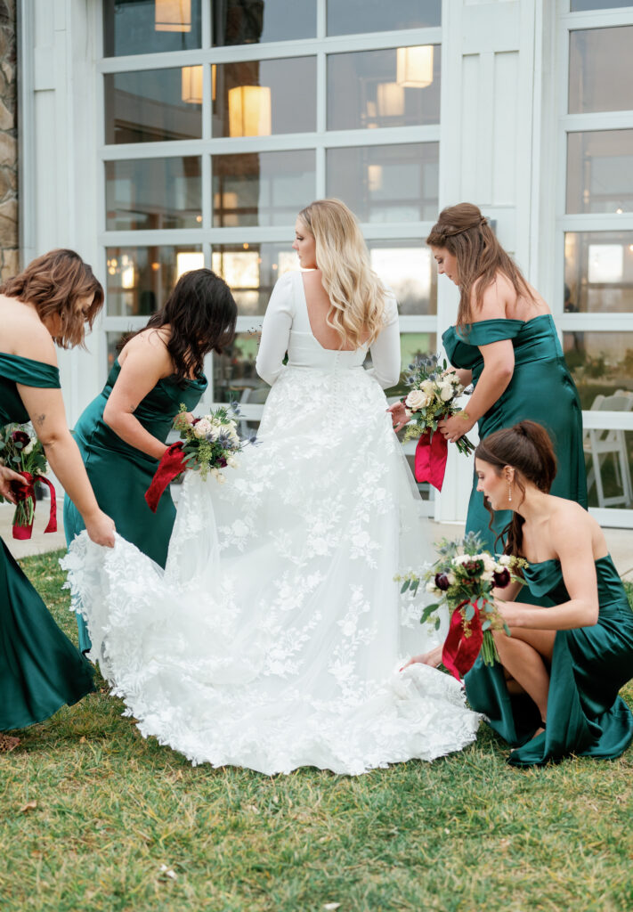 Bridesmaids helping with wedding dress. 