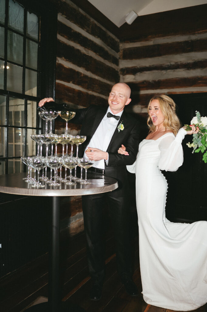 Couple pouring champagne at wedding 